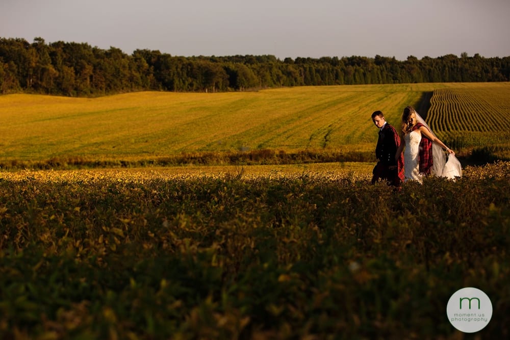 Cornwall Rustic Country Wedding - bride and groom walking through soy field