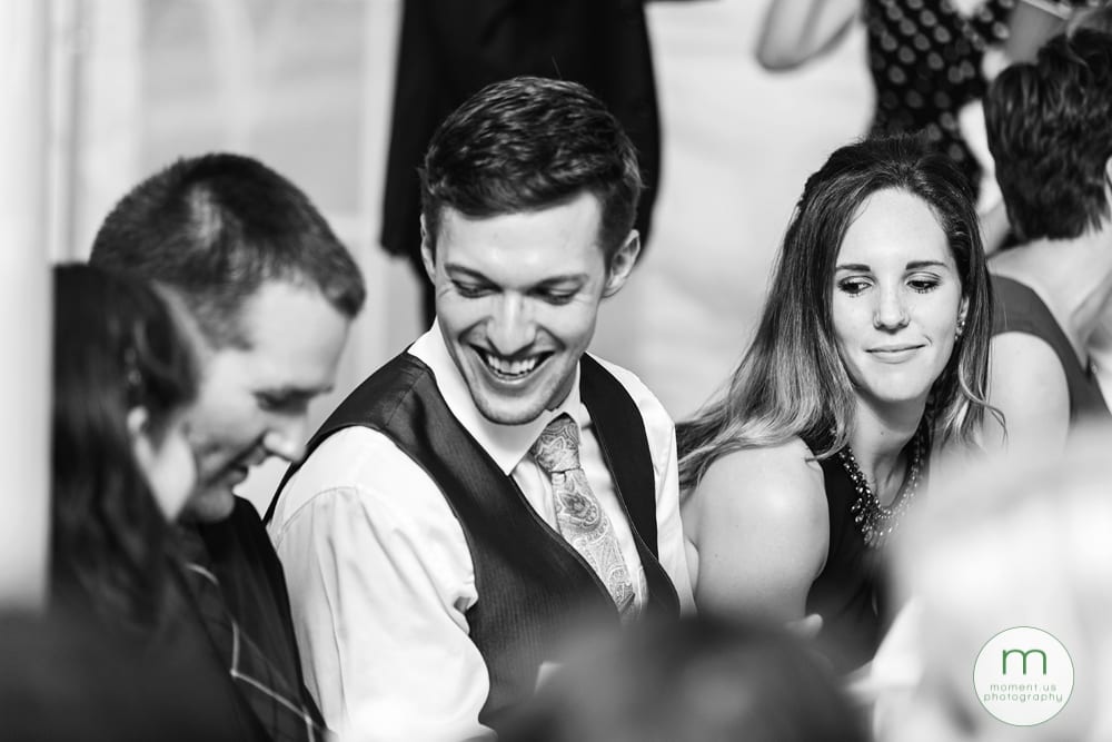 Cornwall Rustic Country Wedding - guest looking at neighbour's photo