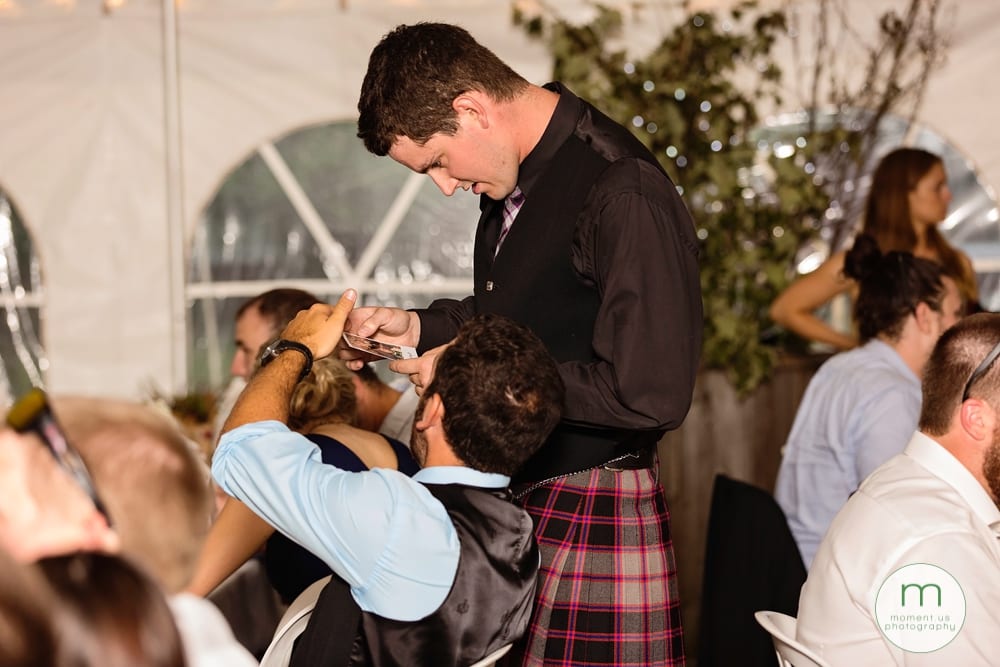 Cornwall Rustic Country Wedding - two men looking at photos