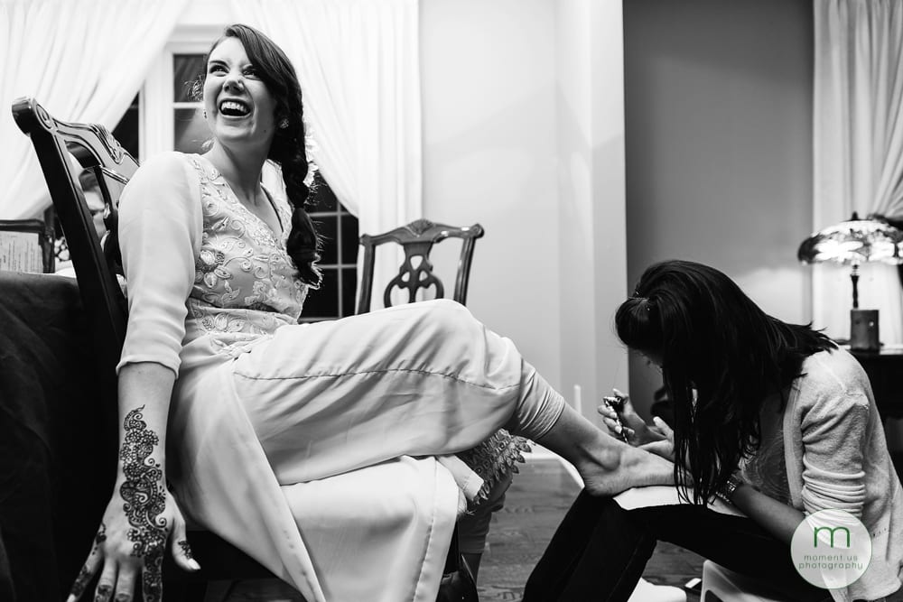 bride getting mehndi on foot