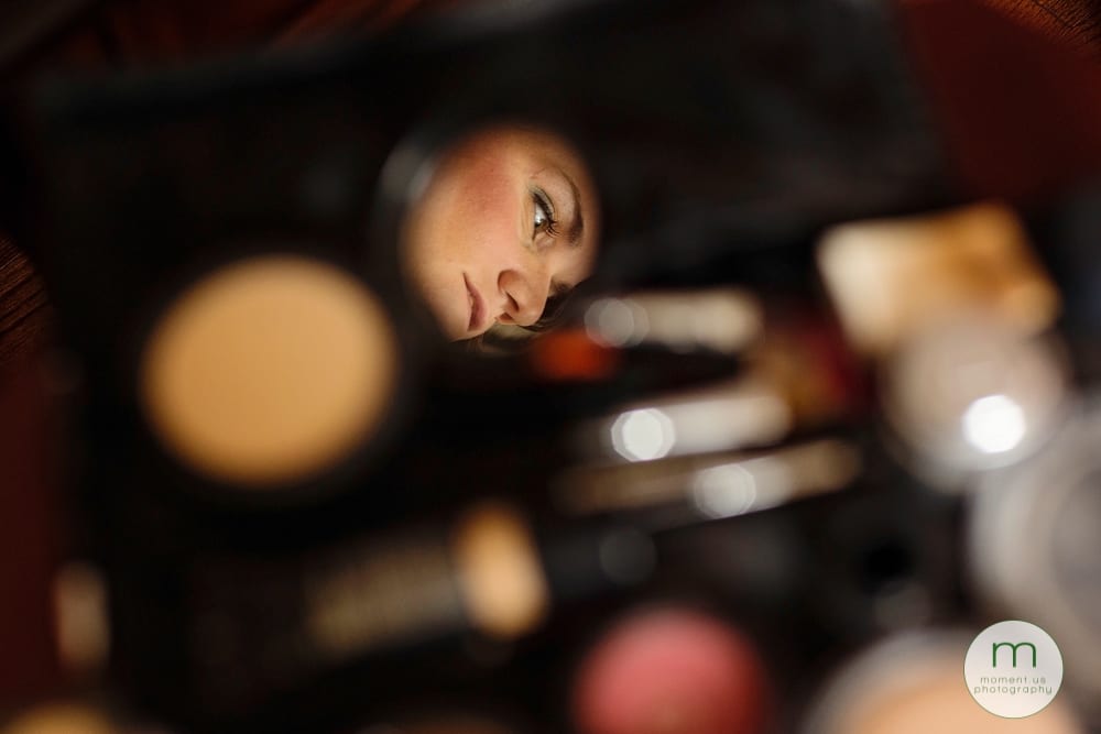 face in makeup mirror