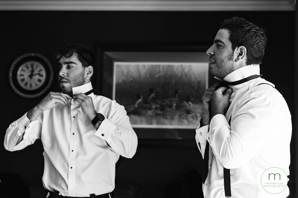 groom and brother putting on ties