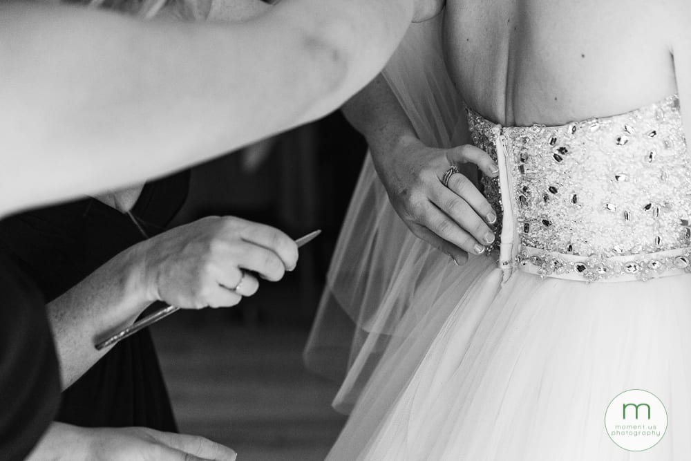 bridesmaids fixing dress with butter knife