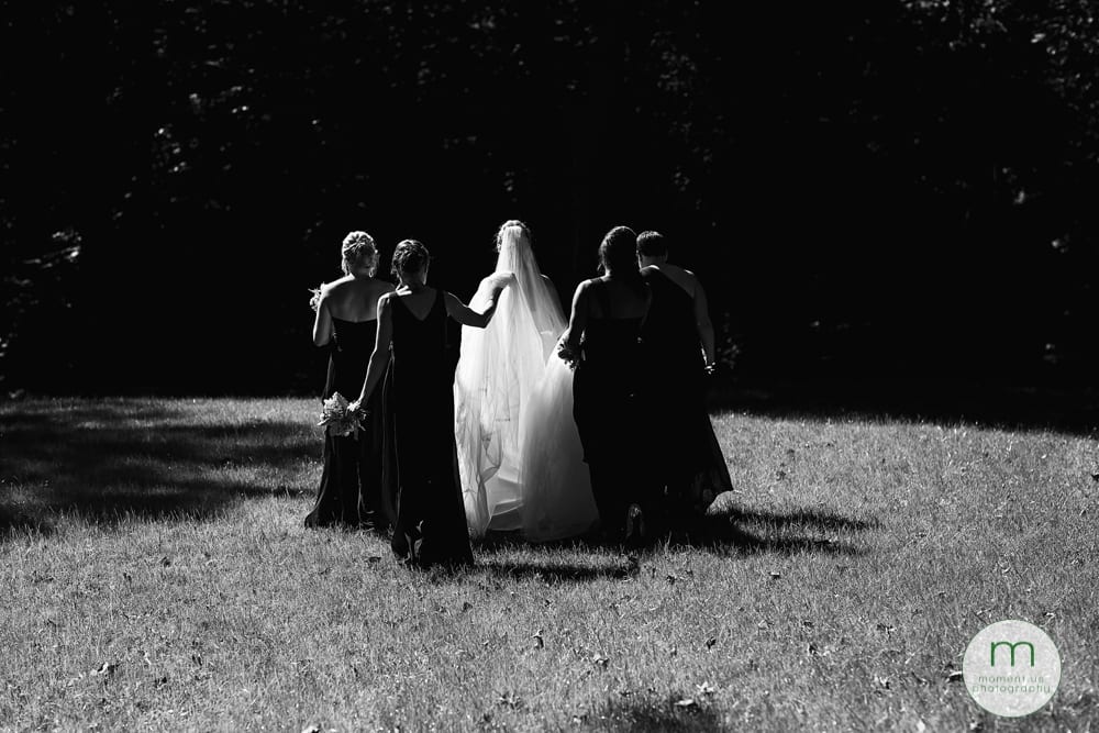 bride walking into sun with girls