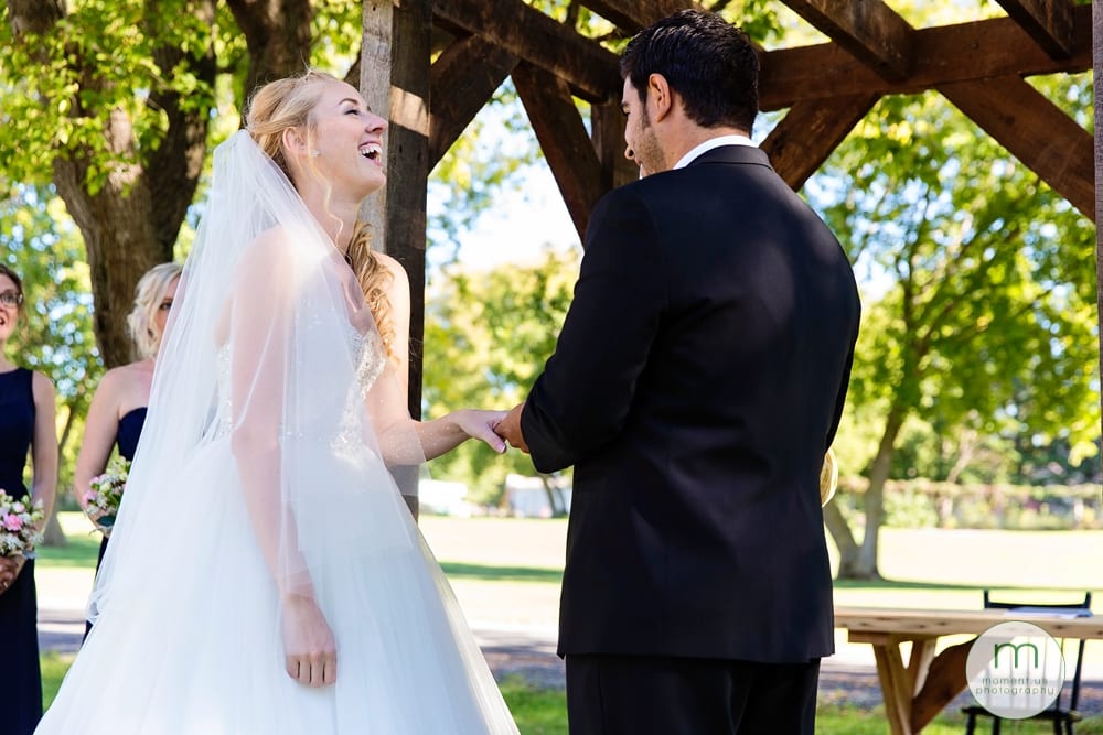 bride laughing during ring exchange