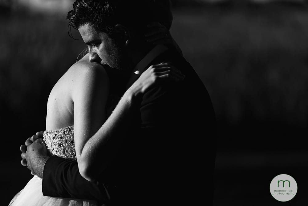 groom kissing bride's shoulder