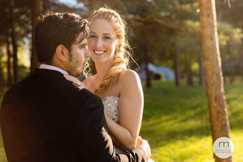 bridal portrait - bride looking at camera amongst trees