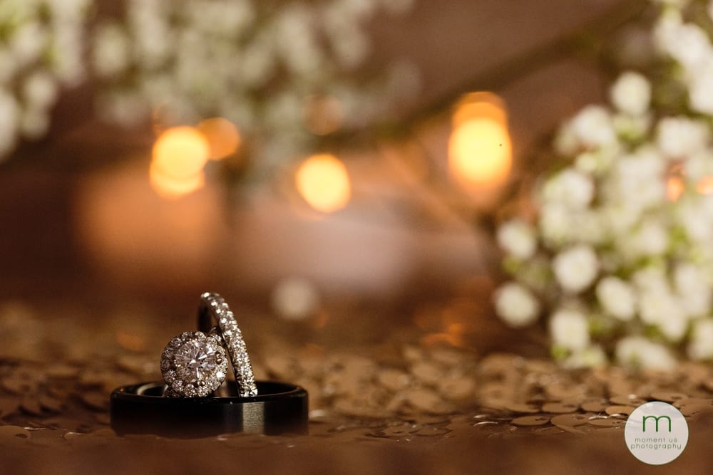 rings in front of candles and baby's breath