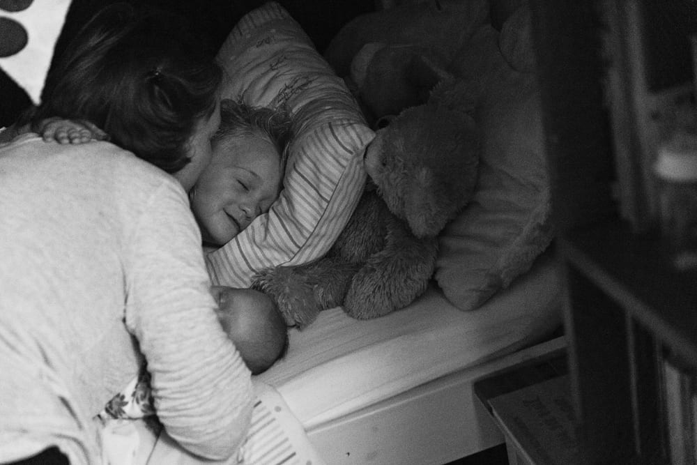 Stockholm mom kissing daughter goodnight