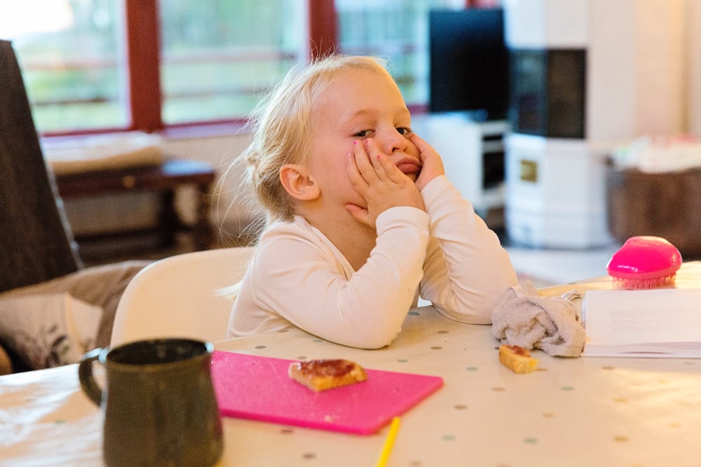 Stockholm girl resting chin on hands at table