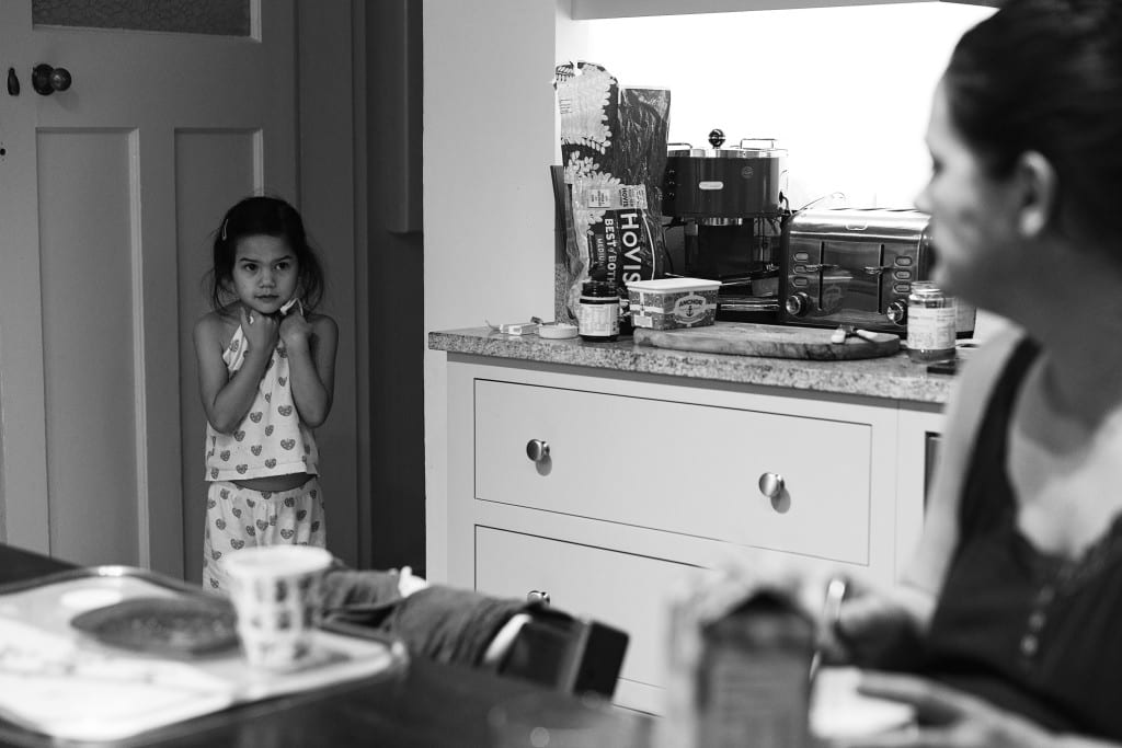 girl in pjs talking to mom 