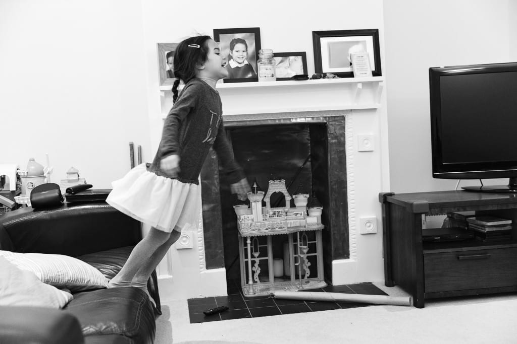 girl jumping off couch