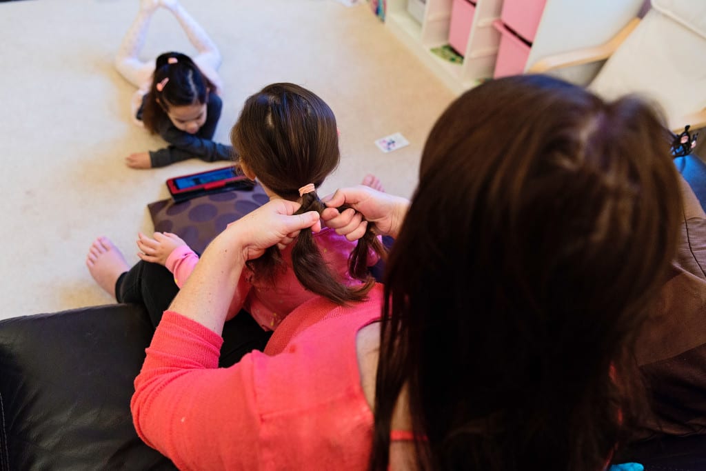 mom doing daughter's hair