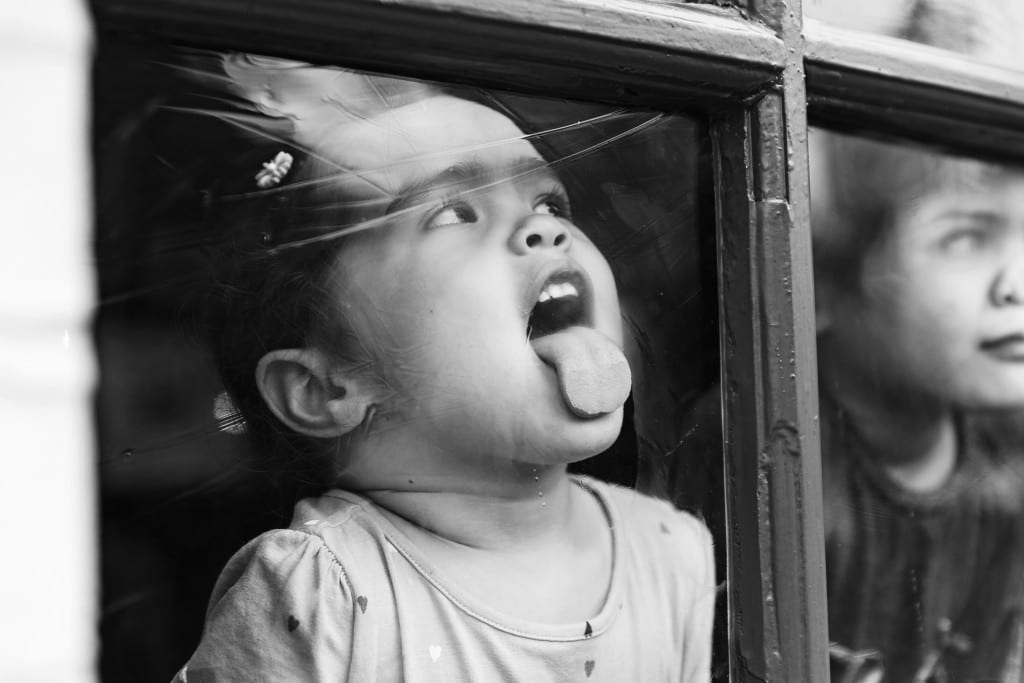 London girl licking pub window