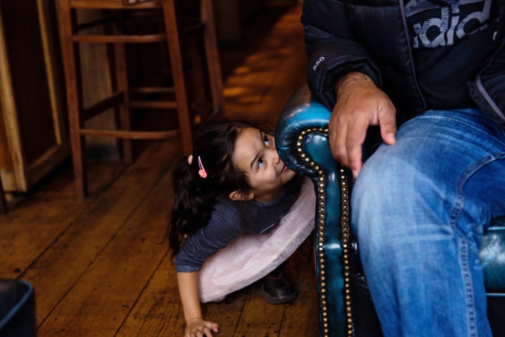 London girl looking up from under chair