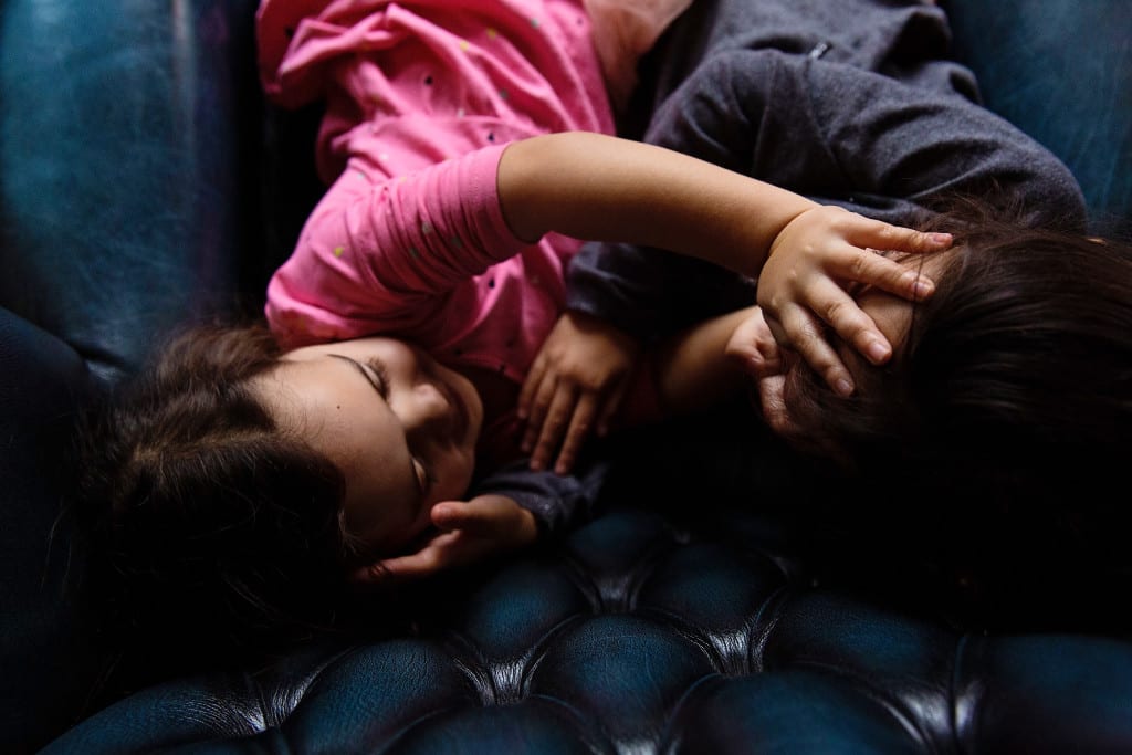 London girls playing with hands on faces