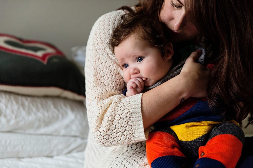 London mom and baby on bed