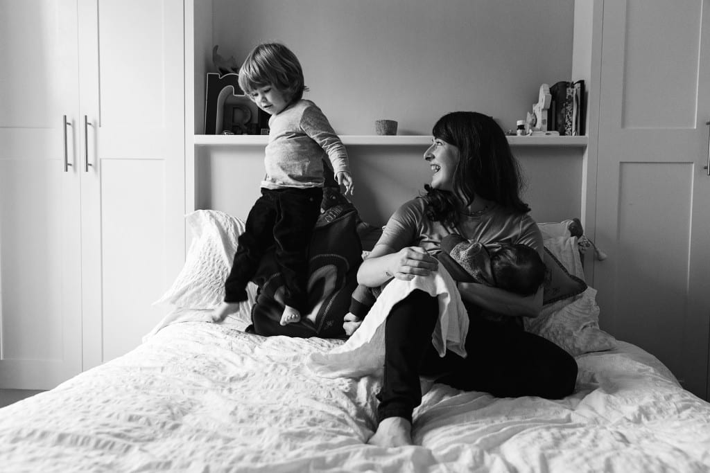 London mom and sons on bed