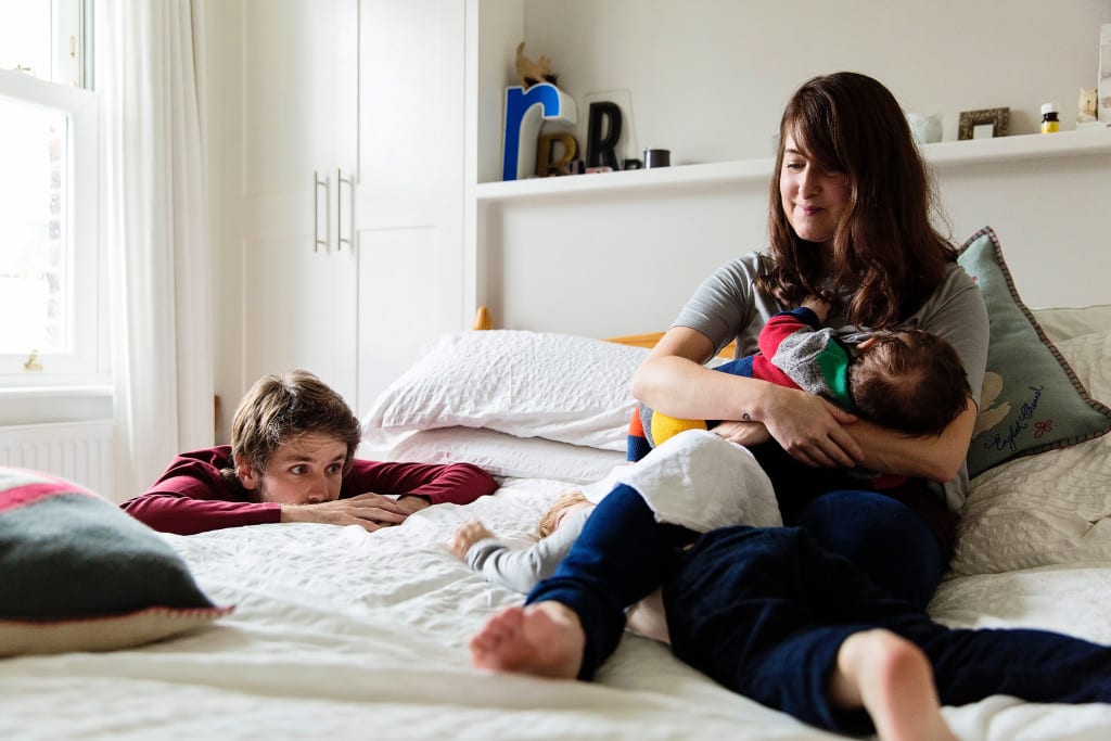 London family on bed boy trapped beneath moms leg