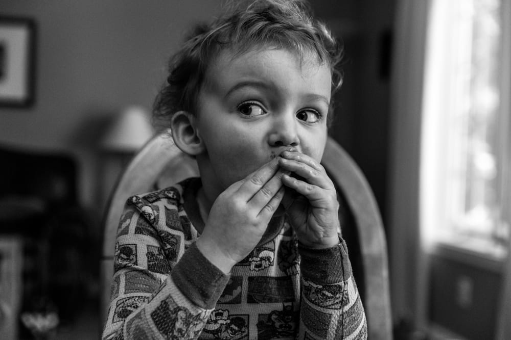 Cornwall family photography - boy eating frozen fruit