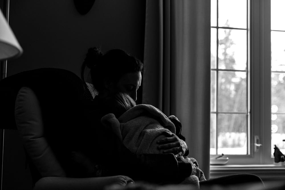 Cornwall family photography - mom cuddling child in chair