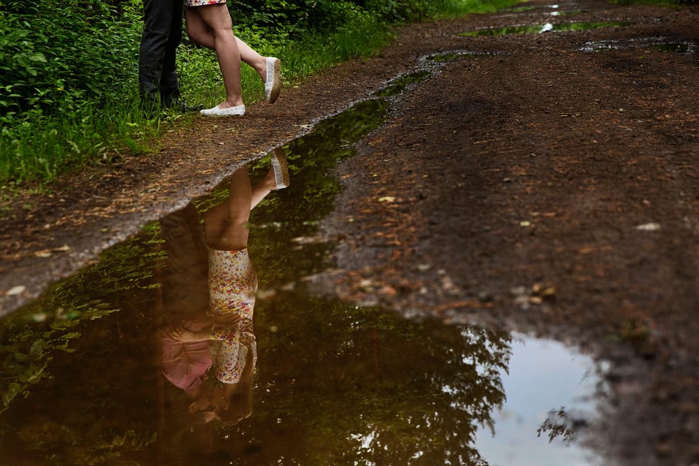 Ontario wedding photographer - couple cuddling for Cornwall engagement photos along dirt road