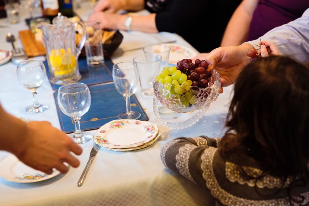Passing grapes during Manchester family lunch