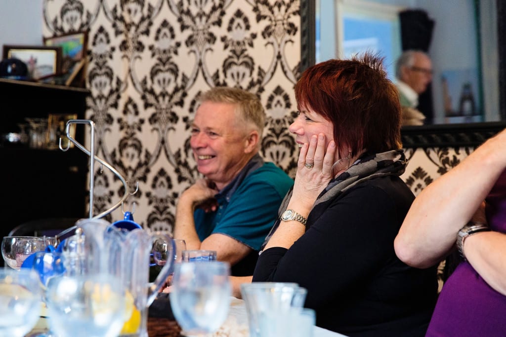 Husband and wife laughing during Manchester family lunch