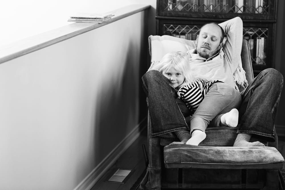 Cornwall family photographer - daughter with dad after reading