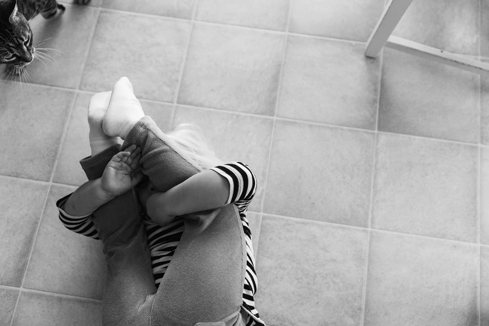 Cornwall family photographer - sister with ankles around head