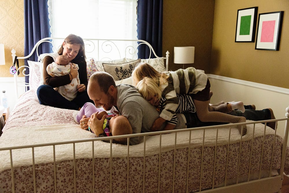 Cornwall family photographer - family piled on bed