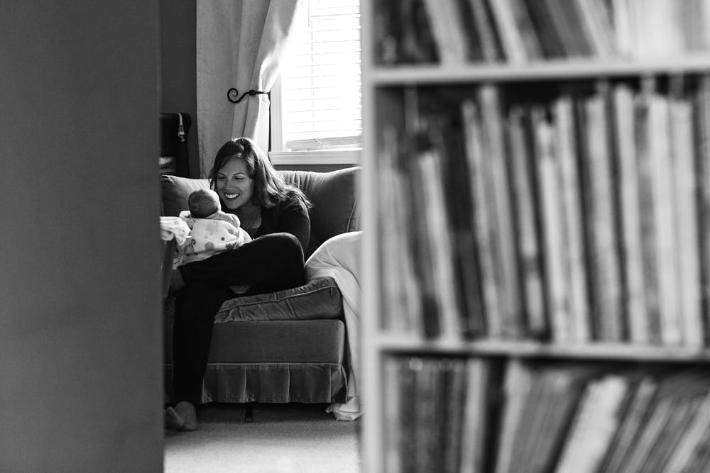 Cornwall family photographer - mom with baby in armchair
