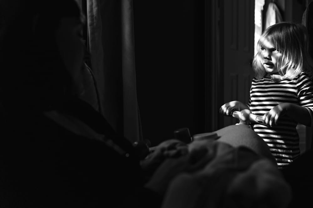 Cornwall family photographer - daughter with mom in nursery