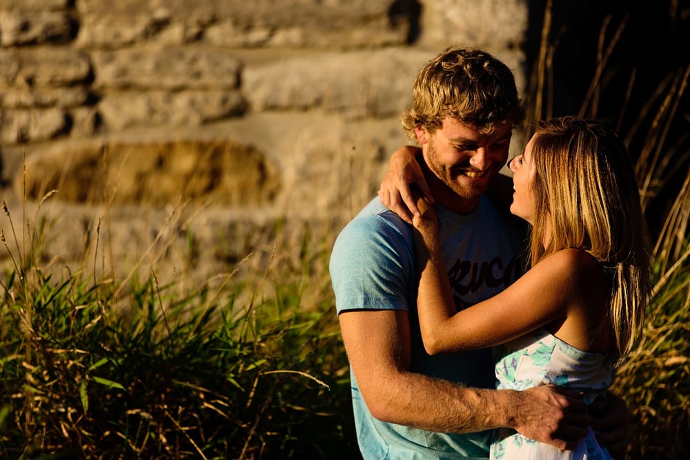 Ontario wedding photographer - couple cuddling for Cornwall engagement photos along the Raisin River
