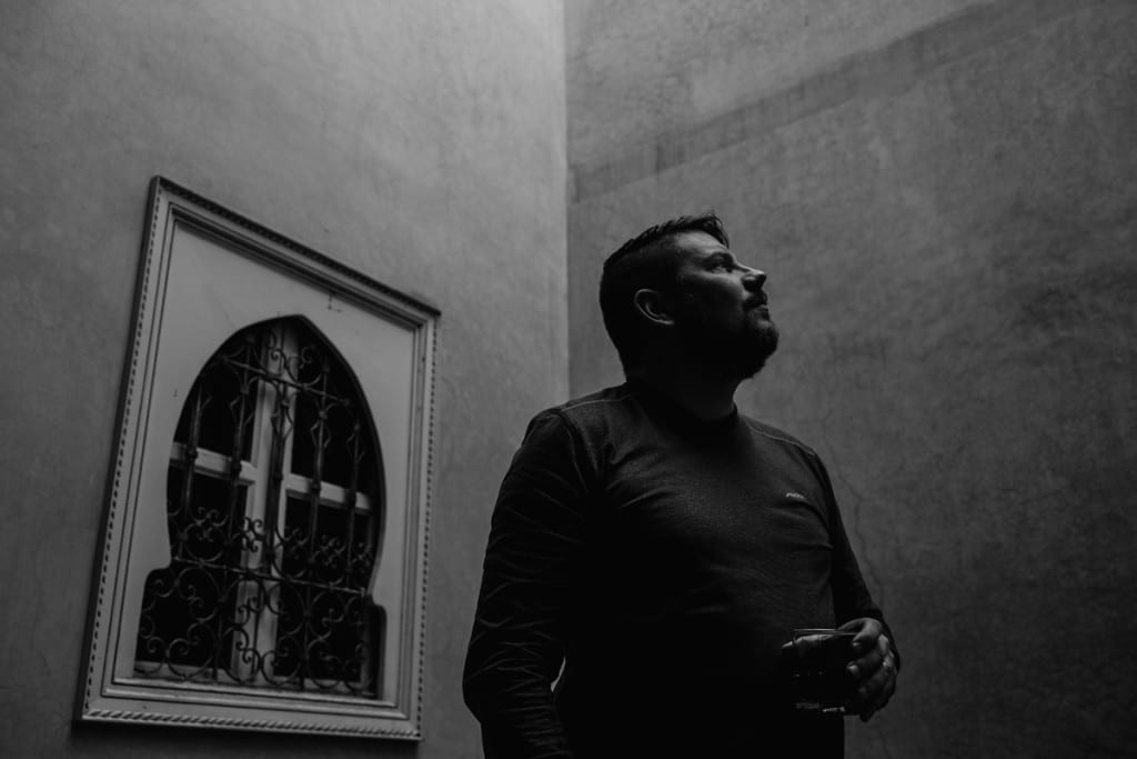 Wedding photographer in Morocco - man looking around Marrakech riad