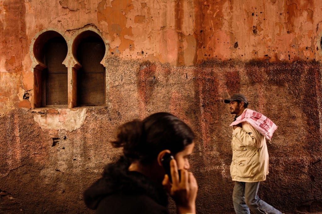 Wedding photographer in Morocco - man and woman pass in alley