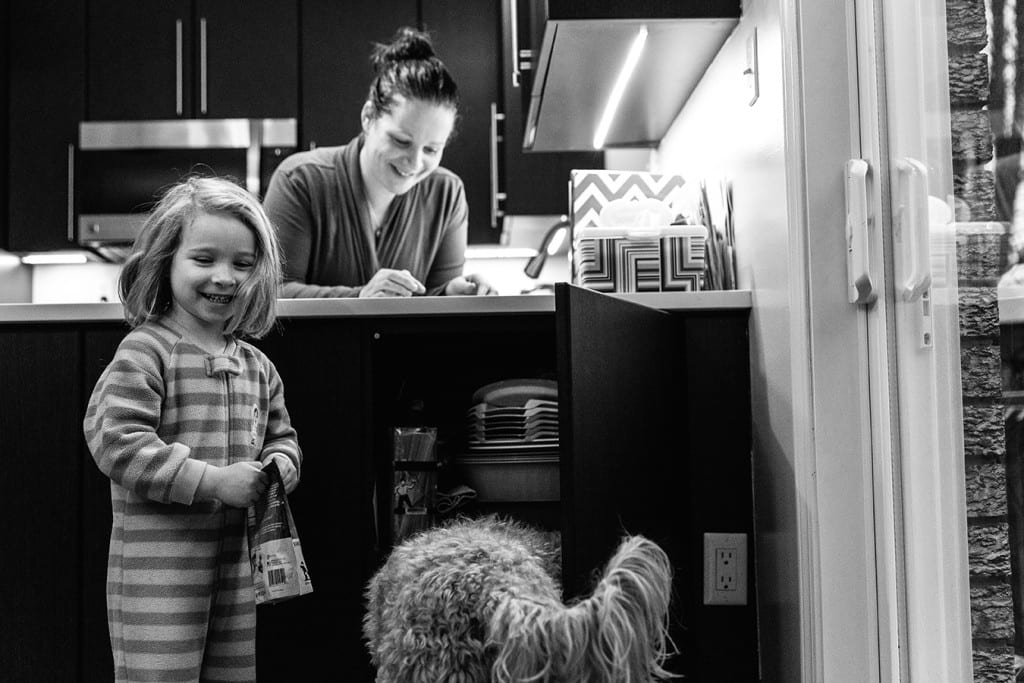 daughter feeding dog