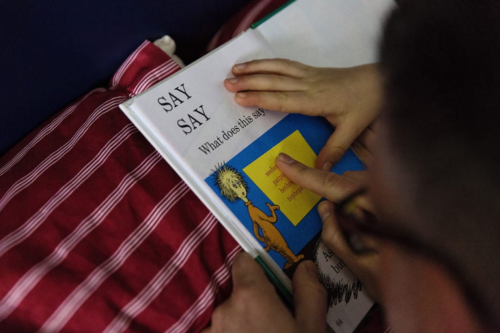 son working on reading with dad