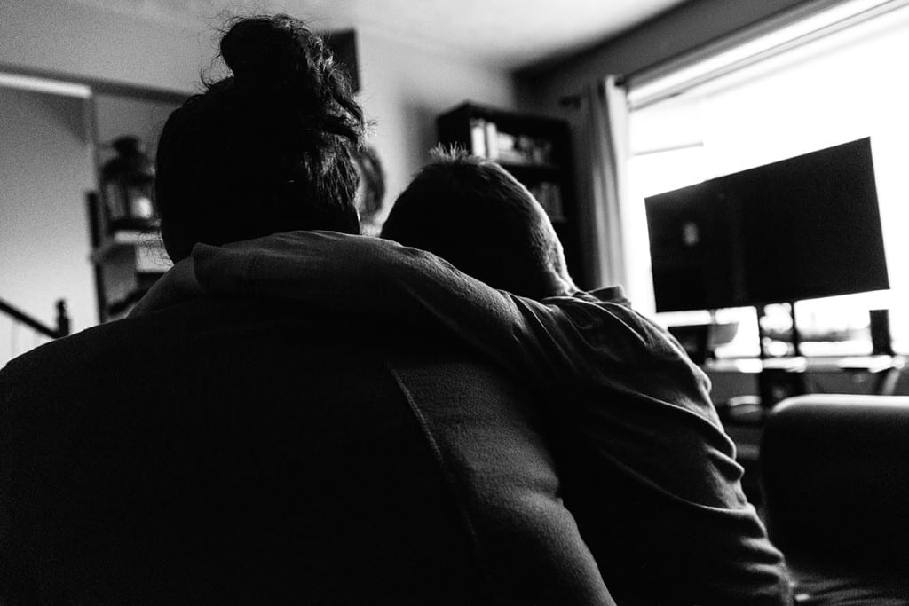 Son hugging mom - family photography in Cornwall