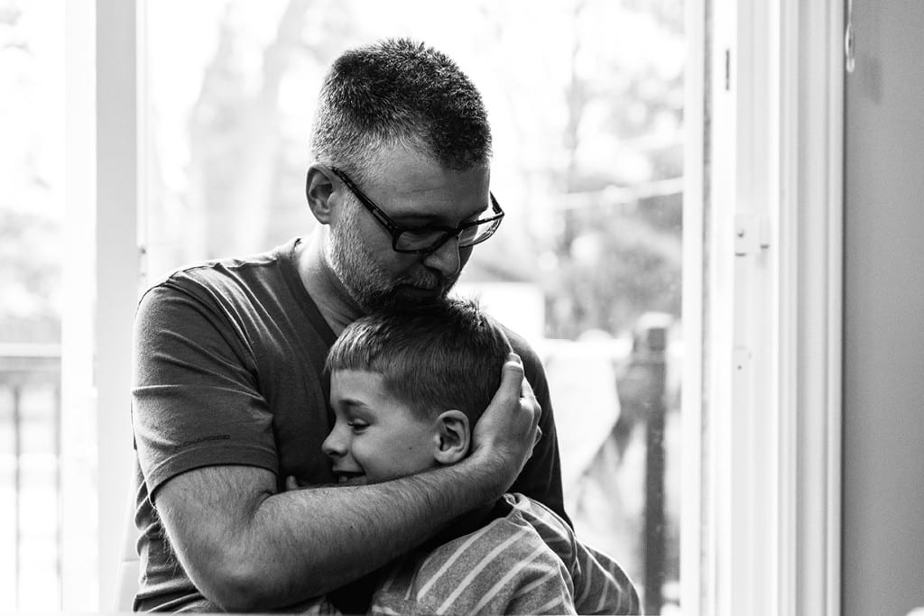 dad hugging son's head