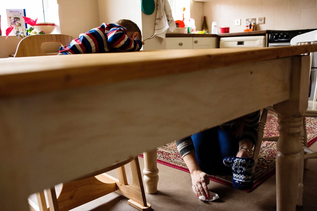 mom and son attending to mess on floor
