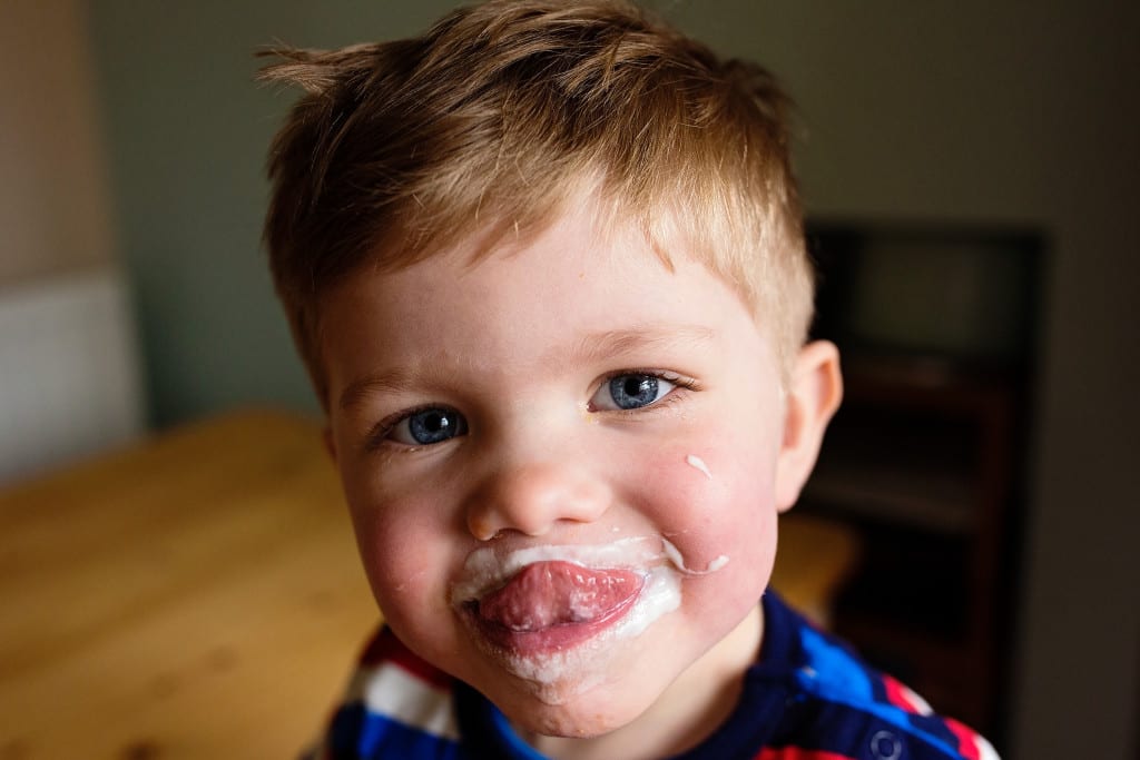 boy with yogurt on face
