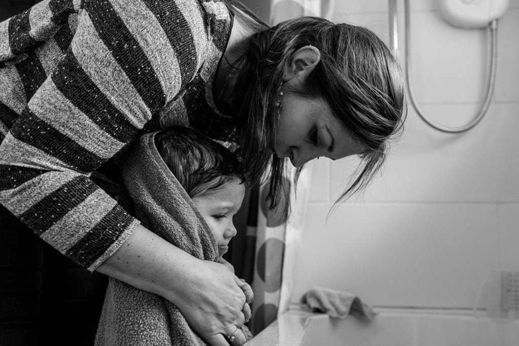 mom wrapping son in towel during session with South Wales family photographer