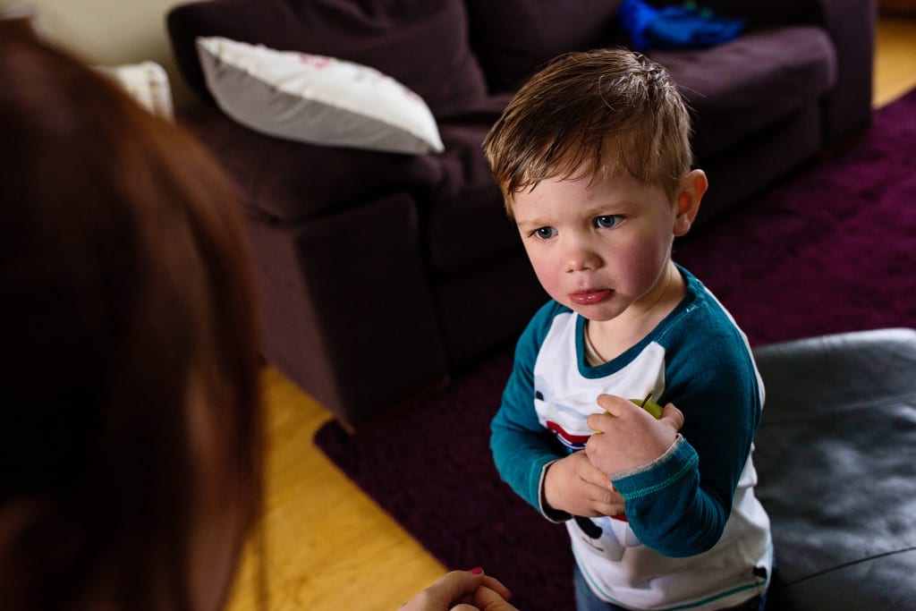 boy looking sad holding apple