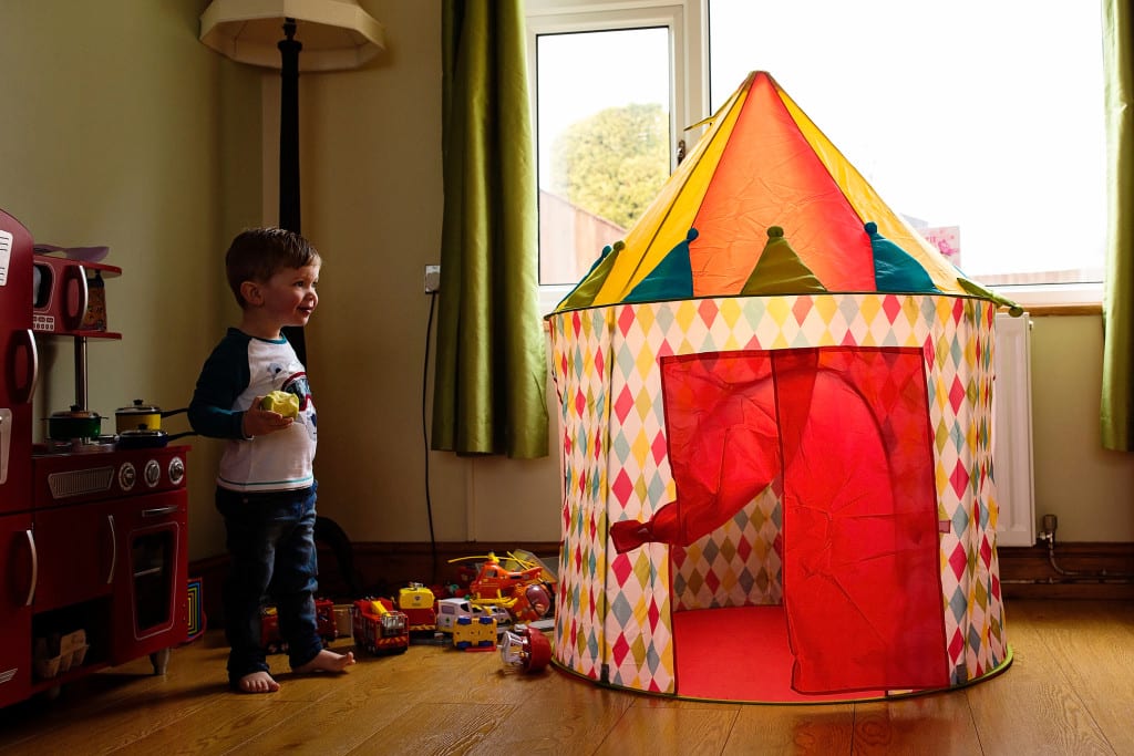 boy looking at play tent