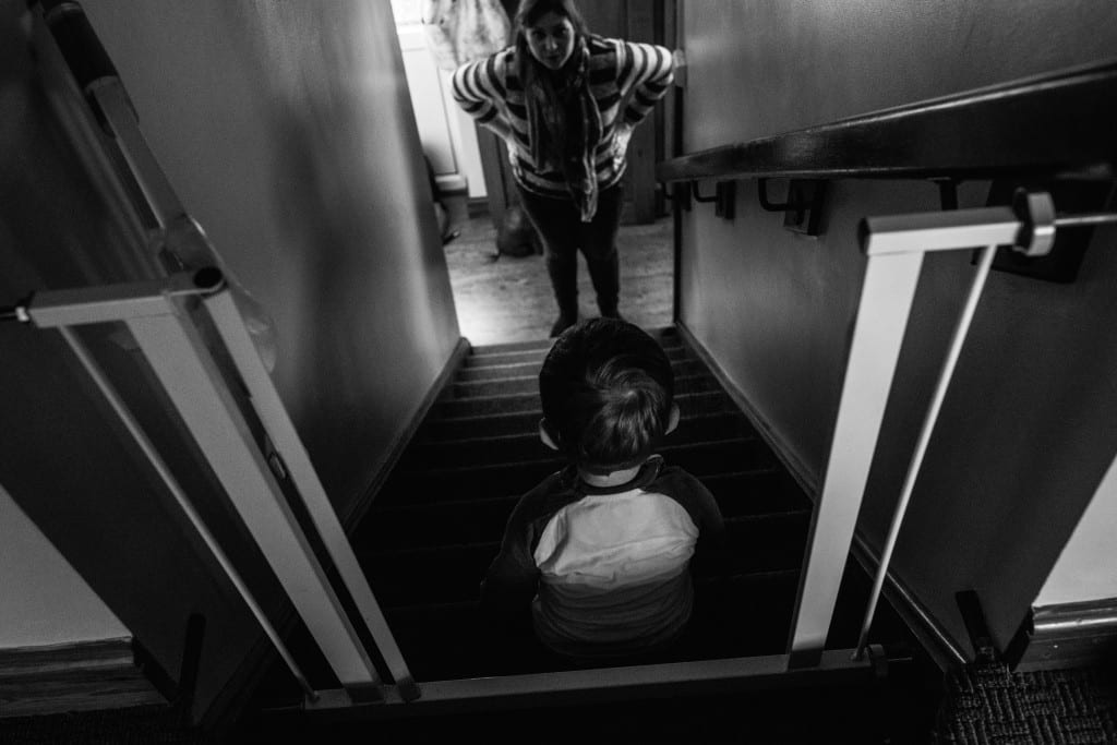 mom talking to son on stairs during South Wales family photo session