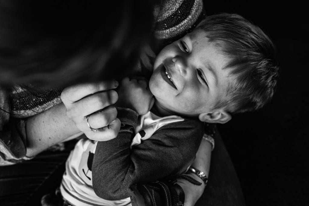 mom tickling son during South Wales family session