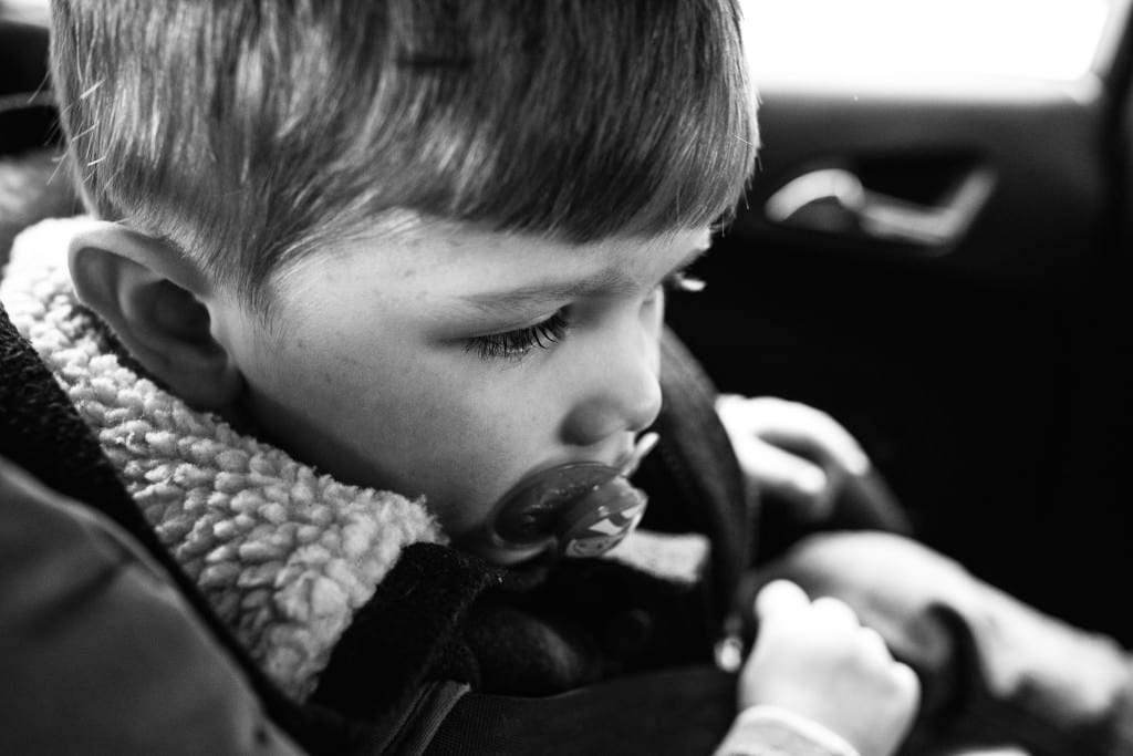 boy sitting in car during South Wales family session 