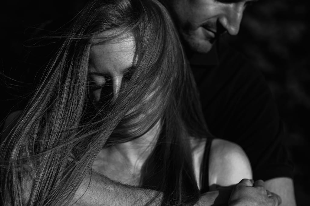 hair blowing in woman's face during Cornwall engagement session
