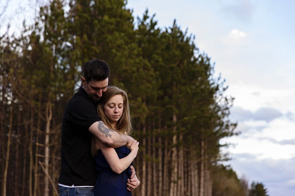 portrait near pines during Cornwall engagement session